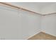 Walk-in closet featuring neutral flooring and wooden bar for hanging clothes at 100 Beaver Falls Ave, Las Vegas, NV 89123