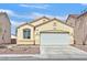 Charming one-story home featuring a well-maintained front yard, desert landscaping, and a two-car garage at 100 Beaver Falls Ave, Las Vegas, NV 89123