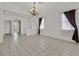 Spacious living room with tile floors, neutral colors, and natural light streaming through the windows at 100 Beaver Falls Ave, Las Vegas, NV 89123