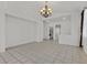 The expansive living room offers tile floors, neutral walls, and a view into other rooms at 100 Beaver Falls Ave, Las Vegas, NV 89123