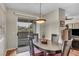 Bright dining area features modern light fixture and view to the outside patio at 1012 Domnus Ln # 105, Las Vegas, NV 89144