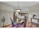 Cozy dining area with a modern light fixture, hardwood floors and easy access to the kitchen at 1012 Domnus Ln # 105, Las Vegas, NV 89144