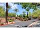 Community entrance featuring landscaping, gated access, and lush tropical palm trees at 1012 Domnus Ln # 105, Las Vegas, NV 89144