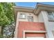 Condominium building exterior featuring the unit numbers and a partial view of a tree at 1012 Domnus Ln # 105, Las Vegas, NV 89144