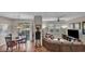 A view of the living and dining area showcasing an open design with updated fixtures and hardwood floors at 1012 Domnus Ln # 105, Las Vegas, NV 89144