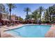 Community pool with palm trees, lounge chairs, and a jacuzzi at 1012 Domnus Ln # 105, Las Vegas, NV 89144