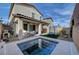 Backyard featuring a splash pool, covered patio, artificial turf, and surrounding fence at 10397 Skye Canyon Falls Ave, Las Vegas, NV 89166