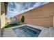 Private backyard features a splash pool, trampoline, and high brick wall at 10397 Skye Canyon Falls Ave, Las Vegas, NV 89166
