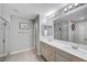 Well-lit bathroom with double sinks, ample counter space, a large mirror, and a glass-enclosed shower at 10397 Skye Canyon Falls Ave, Las Vegas, NV 89166