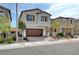 Charming two-story home featuring a well-manicured lawn and an attached two-car garage at 10397 Skye Canyon Falls Ave, Las Vegas, NV 89166