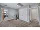 Spacious carpeted hallway with access to multiple rooms, featuring white trim and a closet for storage at 10397 Skye Canyon Falls Ave, Las Vegas, NV 89166