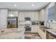 Modern kitchen featuring stainless steel appliances, granite counters, subway tile backsplash, and wooden floors at 10397 Skye Canyon Falls Ave, Las Vegas, NV 89166