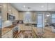 Bright kitchen with granite countertops, stainless steel appliances, wooden floors and sliding door access to the backyard at 10397 Skye Canyon Falls Ave, Las Vegas, NV 89166