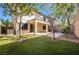 Large backyard with synthetic grass, covered patio, and privacy wall, ideal for relaxation and entertaining at 1077 Lemongrass Ct, Henderson, NV 89002