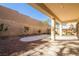 Spacious backyard featuring rock landscaping, a concrete patio area, privacy wall, and covered patio at 1077 Lemongrass Ct, Henderson, NV 89002