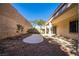 Backyard featuring rock landscaping, a concrete patio area, privacy wall, and covered patio at 1077 Lemongrass Ct, Henderson, NV 89002