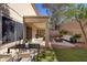 Inviting backyard with covered patio, modern fire pit, and ample seating for outdoor entertainment at 1077 Lemongrass Ct, Henderson, NV 89002