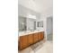 Spacious bathroom featuring double sinks, a large mirror and tile flooring at 1077 Lemongrass Ct, Henderson, NV 89002