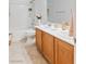 Bright bathroom featuring a shower-tub combination and dual vanity with beige tile flooring at 1077 Lemongrass Ct, Henderson, NV 89002