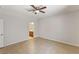 Bedroom with tile flooring, ceiling fan, and doorway to a bathroom at 1077 Lemongrass Ct, Henderson, NV 89002