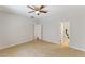 Empty bedroom with tile floors, ceiling fan, and entry to a bathroom and closet at 1077 Lemongrass Ct, Henderson, NV 89002