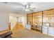 Spacious room with carpeted flooring, a ceiling fan, built-in shelving, and wood railing at 1077 Lemongrass Ct, Henderson, NV 89002