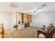 Spacious room with carpeted flooring, a ceiling fan, built-in shelving, and a comfortable leather couch at 1077 Lemongrass Ct, Henderson, NV 89002