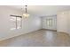 Bright dining area with tile floors, a modern chandelier, and plenty of natural light, creating a welcoming space at 1077 Lemongrass Ct, Henderson, NV 89002