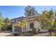 Side view of a two-story home with a tile roof and manicured landscaping, including a two-car garage at 1077 Lemongrass Ct, Henderson, NV 89002