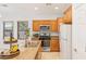 Kitchen with wood cabinetry, stainless steel appliances, and a practical breakfast bar, offering a modern and functional space at 1077 Lemongrass Ct, Henderson, NV 89002