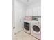 Functional laundry room with modern washer and dryer units and ample storage cabinets at 1077 Lemongrass Ct, Henderson, NV 89002