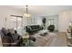 Staged living room showcasing modern decor, including a comfortable sofa, stylish rug, and abundant natural light at 1077 Lemongrass Ct, Henderson, NV 89002