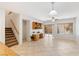 Open-concept living room featuring tile flooring, a built-in desk area, and sliding glass doors leading to an outdoor space at 1077 Lemongrass Ct, Henderson, NV 89002