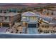 Elevated view of an elegant two-story home with mountain views at 12453 Foxtail Run Ave, Las Vegas, NV 89138