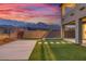 Backyard showcases a patio area and lush artificial grass at 12453 Foxtail Run Ave, Las Vegas, NV 89138