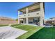 Spacious backyard featuring artificial grass, a concrete area, and a covered patio perfect for outdoor entertaining at 12453 Foxtail Run Ave, Las Vegas, NV 89138