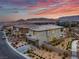 Exterior shot shows the 2-story home surrounded by desert landscaping at 12453 Foxtail Run Ave, Las Vegas, NV 89138