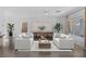 Stylishly staged living room featuring hardwood floors, neutral tones, and ample natural light at 12453 Foxtail Run Ave, Las Vegas, NV 89138