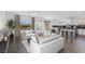 Bright living room with open floor plan, modern furnishings, and backyard view at 12453 Foxtail Run Ave, Las Vegas, NV 89138