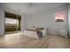 Bright bedroom with hardwood floors, big window, and access to balcony at 12453 Foxtail Run Ave, Las Vegas, NV 89138