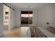 Bright bedroom with hardwood floors, open closet, and access to bathroom at 12453 Foxtail Run Ave, Las Vegas, NV 89138
