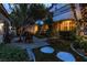 Charming backyard featuring mature landscaping, a fountain, and seating creating a serene outdoor space at 1301 Kingdom St, Las Vegas, NV 89117