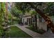 Charming backyard retreat with lush greenery, a cozy patio, and a tranquil water feature at 1301 Kingdom St, Las Vegas, NV 89117