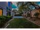 Spacious backyard with green lawn, mature trees, and outdoor lighting, perfect for entertaining at 1301 Kingdom St, Las Vegas, NV 89117