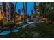 Lush backyard featuring a pool, spa, rock features, a gazebo, and well-manicured landscaping at 1301 Kingdom St, Las Vegas, NV 89117