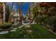 Beautiful backyard with a pool, spa, rock features, a gazebo, and well-manicured landscaping at 1301 Kingdom St, Las Vegas, NV 89117
