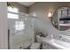 Bathroom featuring glass enclosed shower, toilet, vanity with sink and round mirror at 1301 Kingdom St, Las Vegas, NV 89117