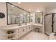 Bright, airy bathroom featuring double vanities, a glass shower, and a soaking tub for a spa-like experience at 1301 Kingdom St, Las Vegas, NV 89117