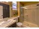 Well-lit bathroom with vanity, shower, and mirrored wall storage at 1301 Kingdom St, Las Vegas, NV 89117