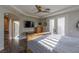 Sunlit bedroom boasts hardwood floors, a ceiling fan, and a mounted TV for ultimate relaxation and entertainment at 1301 Kingdom St, Las Vegas, NV 89117